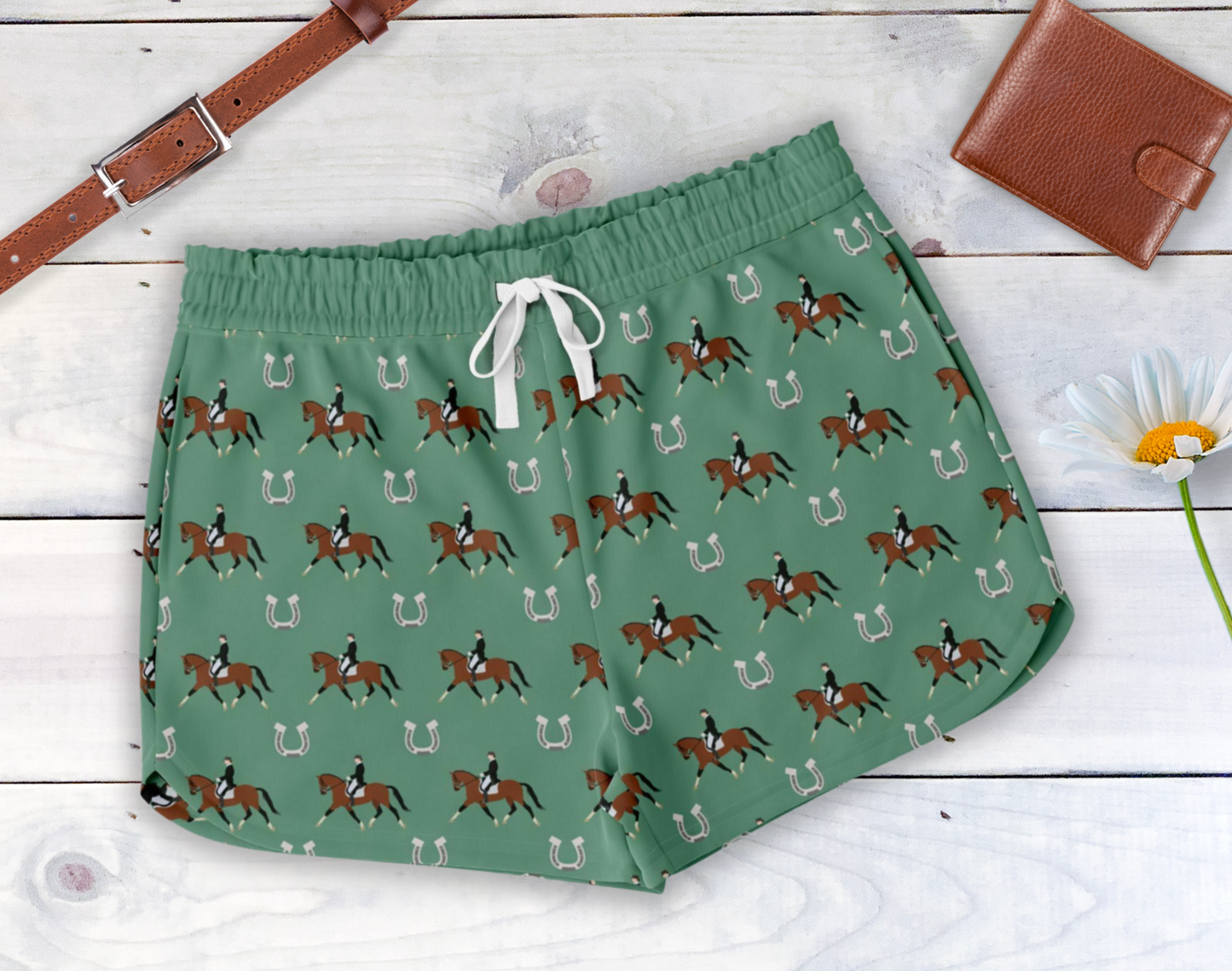 Dark green lounge shorts featuring a dressage rider and horseshoe print. Shorts feature a back pocket, side pockets and a white drawstring waist.